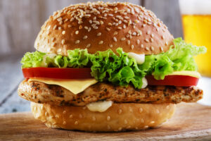 Burger with grilled chicken and cheese. Romaine Lettuce E. coli outbreak warning